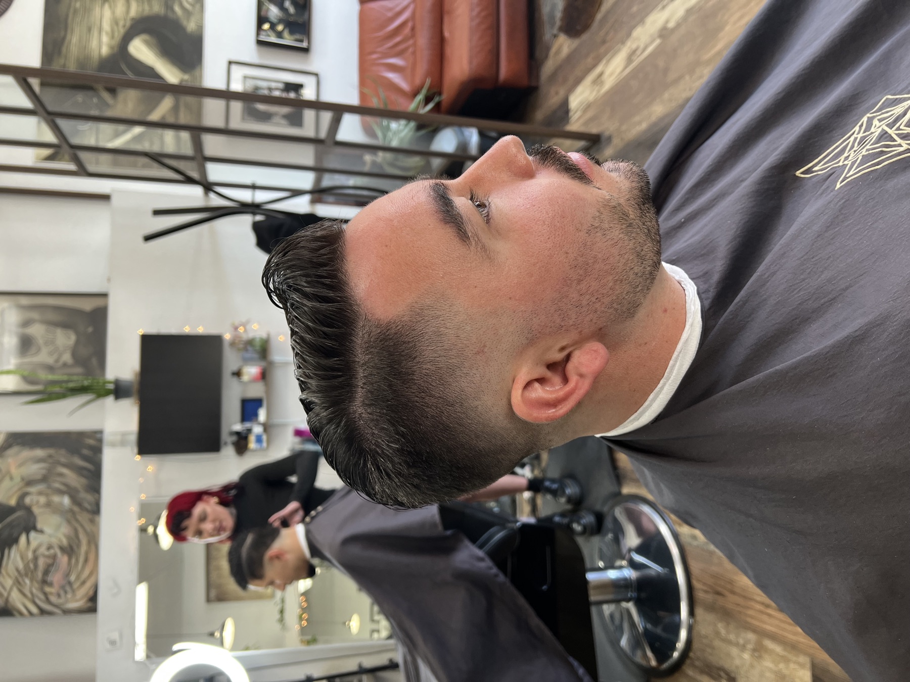 Side-part haircut with a clean fade from Noble Wolf Barbers