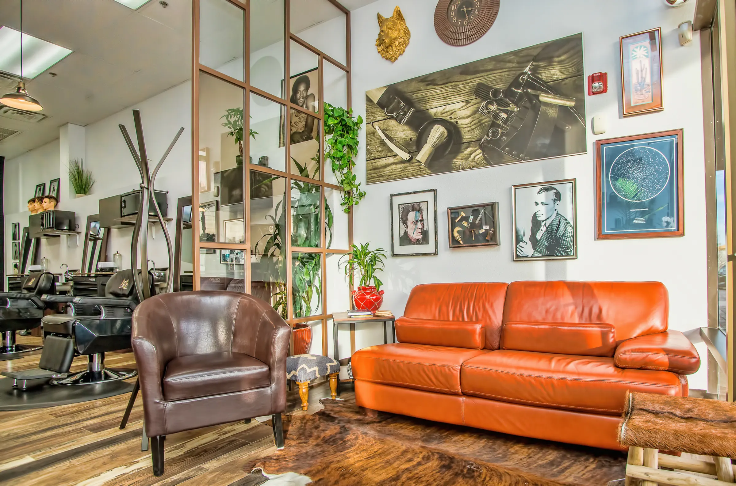 The Den’s gold wolf, leather lounge and barber chairs behind the glass