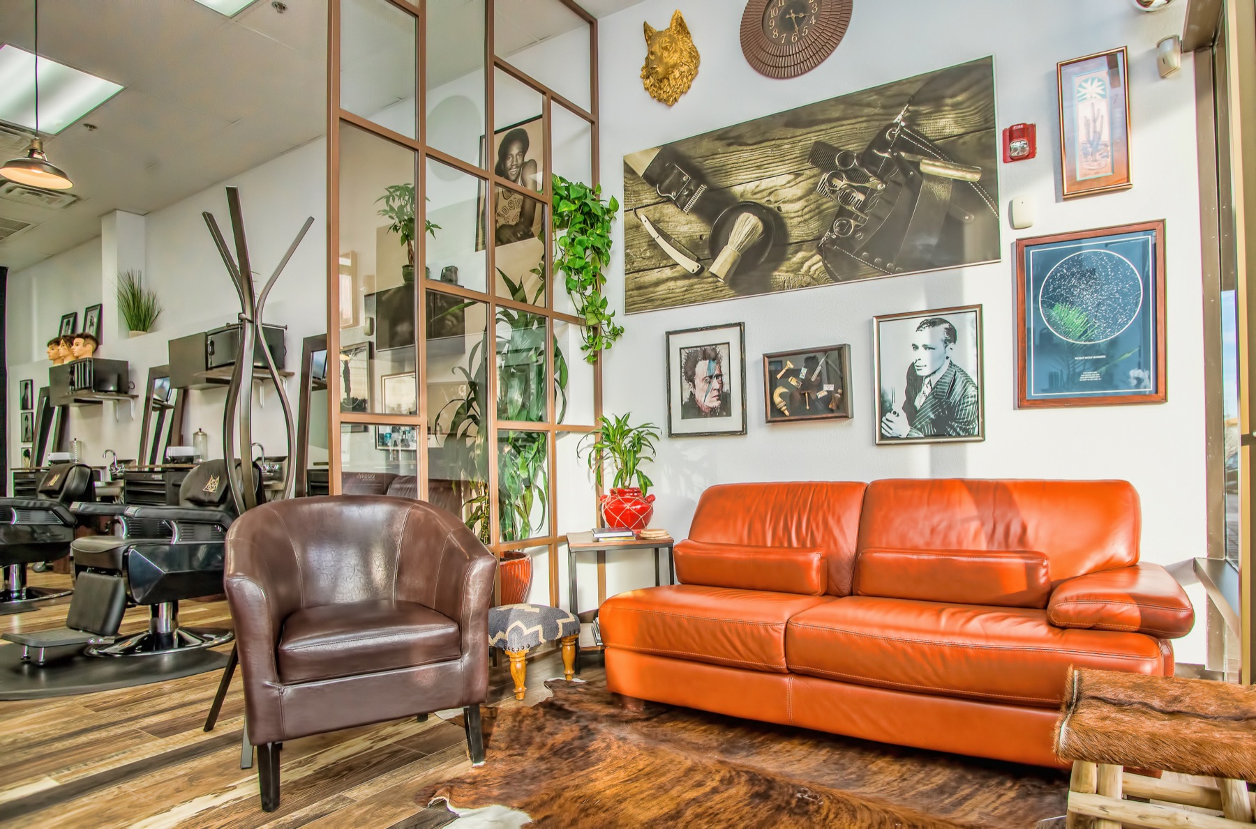 The Den lounge, with the gold wolf, couch and barber chairs